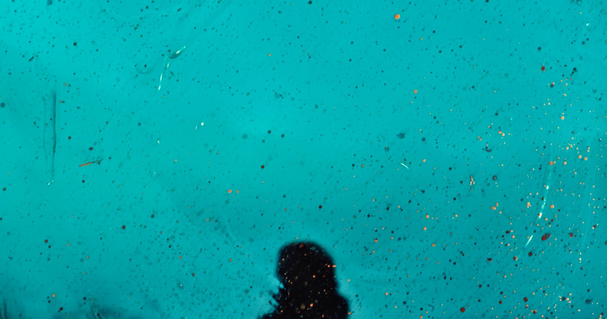 a person standing in front of a blue wall